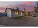A spacious backyard with desert landscaping featuring a covered patio with comfortable seating at 5529 W Villa Maria Dr, Glendale, AZ 85308