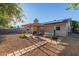 Backyard view with gravel, patio, solar panels, and patio furniture at 5529 W Villa Maria Dr, Glendale, AZ 85308