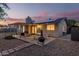 An inviting backyard featuring a covered patio with comfortable seating and outdoor dining at 5529 W Villa Maria Dr, Glendale, AZ 85308