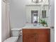 Compact bathroom with a wood vanity, a mirror, and standard fixtures at 5529 W Villa Maria Dr, Glendale, AZ 85308