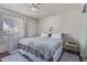 Light-filled bedroom with a cozy bed, neutral decor, and stylish window treatments at 5529 W Villa Maria Dr, Glendale, AZ 85308