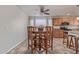 Open dining area features tile floors, a ceiling fan, and a round wooden dining table set at 5529 W Villa Maria Dr, Glendale, AZ 85308