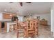 Open dining area view showcases tile flooring, with a wooden dining table and view to kitchen at 5529 W Villa Maria Dr, Glendale, AZ 85308