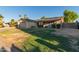 Charming single-story home with a two-car garage, solar panels, a patio, and desert landscaping at 5529 W Villa Maria Dr, Glendale, AZ 85308