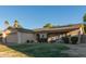 Charming single-story home with a two-car garage, solar panels, a patio, and desert landscaping at 5529 W Villa Maria Dr, Glendale, AZ 85308