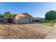 This lovely home has a two-car garage, a spacious driveway, and low-maintenance landscaping at 5529 W Villa Maria Dr, Glendale, AZ 85308