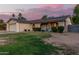 Charming single-Gathering home showcasing solar panels on the roof and a seating area in front at 5529 W Villa Maria Dr, Glendale, AZ 85308