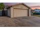 Beige one story home featuring a two-car garage and seating area at 5529 W Villa Maria Dr, Glendale, AZ 85308