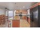 Spacious kitchen with wooden cabinets, tile flooring, stainless steel appliances, and a center island at 5529 W Villa Maria Dr, Glendale, AZ 85308