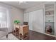 Home office featuring a decorative desk, closet, shelves, and neutral decor at 5529 W Villa Maria Dr, Glendale, AZ 85308