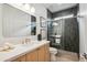 Modern bathroom featuring stylish tiles, a glass-enclosed shower, and a sleek vanity at 5537 E Earll Dr, Phoenix, AZ 85018