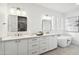 Luxurious bathroom featuring dual sinks, a modern vanity, and a sleek soaking tub for relaxation at 5537 E Earll Dr, Phoenix, AZ 85018