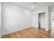 Minimalist bedroom with hardwood floors, a closet, neutral tones, and ample natural light at 5537 E Earll Dr, Phoenix, AZ 85018