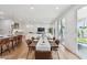 Bright dining area with wooden table and chairs, open to the kitchen and living room, with light-filled windows at 5537 E Earll Dr, Phoenix, AZ 85018