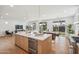 Kitchen featuring an island and white cabinetry, adjoining the dining and living areas at 5537 E Earll Dr, Phoenix, AZ 85018