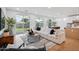 Spacious open concept living area with white sectional, light-filled windows, and view to the backyard at 5537 E Earll Dr, Phoenix, AZ 85018