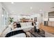 Comfortable living room with a large white sectional couch, wooden floors and ample natural light at 5537 E Earll Dr, Phoenix, AZ 85018