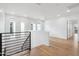 Open loft area with hardwood floors and large windows providing plenty of natural light at 5537 E Earll Dr, Phoenix, AZ 85018