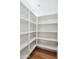 Spacious pantry with built-in shelving and hardwood flooring at 5537 E Earll Dr, Phoenix, AZ 85018