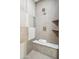 Modern shower featuring unique tile work, a built-in bench, and contemporary fixtures for a spa-like experience at 5537 E Earll Dr, Phoenix, AZ 85018