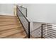 Modern staircase with wood steps and metal railing, leading to the upper level at 5537 E Earll Dr, Phoenix, AZ 85018