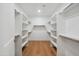 Spacious walk-in closet with custom shelving and hardwood flooring at 5537 E Earll Dr, Phoenix, AZ 85018