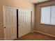 A cozy bedroom features a sliding door closet and natural light at 5635 W Huntington Dr, Laveen, AZ 85339