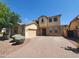Charming two-story home featuring stone accents, a two-car garage, and a brick-paved driveway at 5635 W Huntington Dr, Laveen, AZ 85339