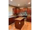 This kitchen features wood cabinets, granite countertops, a center island, and stainless steel appliances at 5635 W Huntington Dr, Laveen, AZ 85339