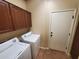 Laundry room with washer, dryer, and storage cabinets at 5635 W Huntington Dr, Laveen, AZ 85339