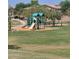 Community playground with slides and climbing structures at 5635 W Huntington Dr, Laveen, AZ 85339