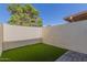 Backyard patio with artificial turf and a view of the surrounding trees at 6004 N 79Th St, Scottsdale, AZ 85250