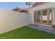 Enclosed backyard features artificial turf, pavers, and patio doors for indoor/outdoor living at 6004 N 79Th St, Scottsdale, AZ 85250