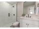 Modern bathroom features glass shower with black hardware and white vanity with marble countertop at 6004 N 79Th St, Scottsdale, AZ 85250