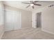 Bright bedroom with ceiling fan, closet with white doors, and neutral walls and carpet at 6004 N 79Th St, Scottsdale, AZ 85250