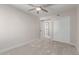 Bedroom with neutral walls, plush carpet, ceiling fan, and closet doors at 6004 N 79Th St, Scottsdale, AZ 85250