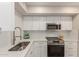 Modern kitchen with white cabinets, stainless steel appliances, and quartz countertops at 6004 N 79Th St, Scottsdale, AZ 85250