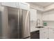 Modern kitchen with stainless steel refrigerator, white cabinets, and quartz countertops at 6004 N 79Th St, Scottsdale, AZ 85250