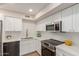 Modern kitchen with white cabinets, stainless steel appliances, and quartz countertops at 6004 N 79Th St, Scottsdale, AZ 85250