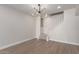 Bright living room featuring wood floors, modern light fixture, and staircase to the next level at 6004 N 79Th St, Scottsdale, AZ 85250