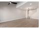 Spacious living room with high ceilings, modern fan, wood floors, and staircase at 6004 N 79Th St, Scottsdale, AZ 85250