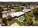 Aerial view showcases a modern home with a white roof, lush backyard pool, and an outdoor seating area at 6102 E Friess Dr, Scottsdale, AZ 85254