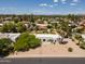 Expansive aerial view of a modern white home with desert landscaping, a gated entry, and distant mountain views at 6102 E Friess Dr, Scottsdale, AZ 85254