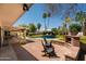 Charming backyard patio with a built-in grill, seating area, and views of the pool and landscaped yard at 6102 E Friess Dr, Scottsdale, AZ 85254