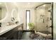 Modern bathroom featuring a double vanity, granite countertop, and a glass enclosed shower at 6102 E Friess Dr, Scottsdale, AZ 85254