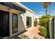 Modern home exterior features sleek black window trim, and a walkway lined with green bushes at 6102 E Friess Dr, Scottsdale, AZ 85254