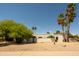 View of modern home with lush desert landscaping, offering privacy and curb appeal at 6102 E Friess Dr, Scottsdale, AZ 85254