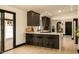 Contemporary kitchen with bar seating, dark cabinets, and open layout to the dining area at 6102 E Friess Dr, Scottsdale, AZ 85254