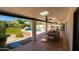 Inviting outdoor patio with a dining area overlooking the pool and lush backyard oasis at 6102 E Friess Dr, Scottsdale, AZ 85254