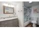 Well-lit bathroom with granite vanity, framed mirror, and shower with glass door at 6349 N 78Th St # 105, Scottsdale, AZ 85250